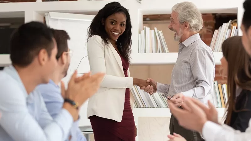 Woman shaking hands with boss